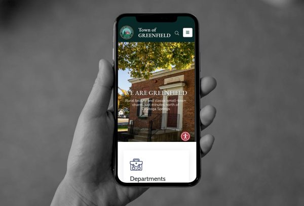 hand holding smartphone displaying new Town of Greenfield website