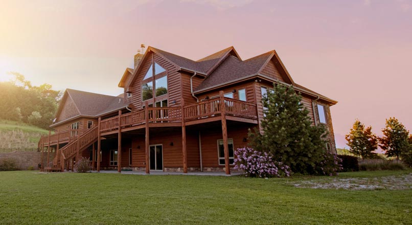 large log cabin home on picturesque property