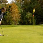man putting on golf green